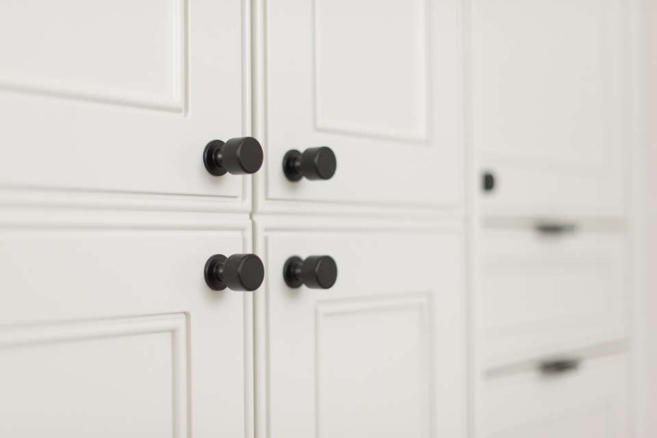 close up of custom built white cabinets in bathroom